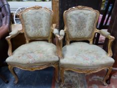 A PAIR OF FRENCH GILT WOOD FAUTEUILS, THE SHAPED SQUARE BACKS, ELBOW RESTS AND SEATS UPHOLSTERED