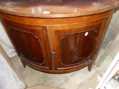 A 19TH CENTURY MAHOGANY BOW FRONT CORNER CABINET.