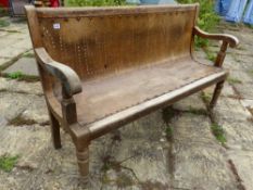 AN ANTIQUE WAITING ROOM BENCH