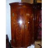 A GEORGE III MAHOGANY BOW FRONT COVER CABINET