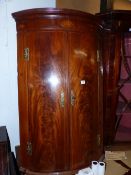 A GEORGE III MAHOGANY BOW FRONT COVER CABINET