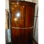 A MAHOGANY BOW FRONT TWO DRAW WARDROBE