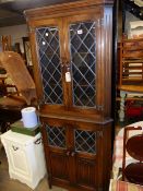 AN OLD CHARM TYPE OAK CORNER CABINET