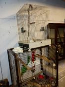 A VINTAGE BIRD CAGE AND A MODERN PARROT CAGE