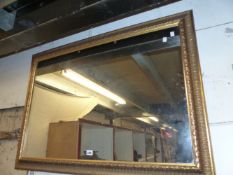 A GILT FRAMED MIRROR