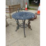 A SMALL CAST METAL PATIO TABLE.