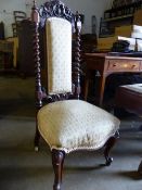 A VICTORIAN WALNUT HIGH BACK NURSING CHAIR.