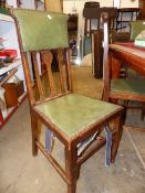 A SET OF SIX OAK ARTS AND CRAFTS OAK DINING CHAIRS.