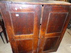 A 17TH/18TH CENTURY OAK TWO PART CABINET WITH PANELLED DOORS.