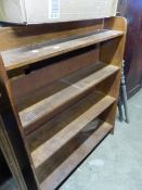 A SMALL OAK OPEN BOOKCASE.