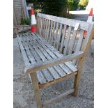 A TEAK GARDEN BENCH