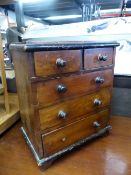 AN ANTIQUE MINIATURE CHEST OF DRAWERS.