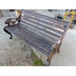 A GARDEN BENCH WITH CAST IRON ENDS.