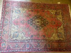 AN ANTIQUE PERSIAN RUG.