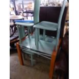 A MODERN GLASS TOP EXTENDING TABLE AND FOUR SIMILAR LEATHER DINING CHAIRS