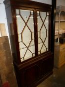 A MAHOGANY GLAZED TWO PART BOOKCASE