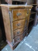 A MINIATURE SERPENTINE FRONT CHEST OF DRAWERS.