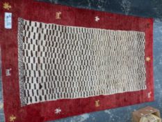 A TRIBAL ORIENTAL RUG, 183 x 119cm TOGETHER WITH A KELIM RUG, 173 x 112cm (2)