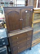 A SMALL OAK FOUR DRAWER CHEST WITH CABINET OVER. W 66 X D 39 X H 130CMS.