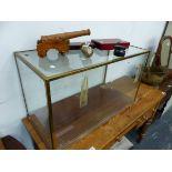 A BRASS FRAMED GLAZED MODEL CAR DISPLAY CASE, TOGETHER WITH A MODEL CANNON, WINE ACCROUTREMENTS ETC.