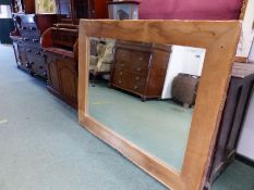 A LARGE RUSTIC FRAMED MIRROR