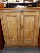 A VICTORIAN SMALL PINE SIDE CABINET WITH PANELLED DOORS. W 87 X D 39 X H 93CMS.