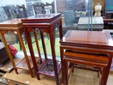 TWO ORIENTAL HARDWOOD URN STANDS AND A NEST OF TWO TABLES.