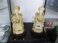 A COMPOSTION FIGURE OF A CHINESE EMPEROR AND OF HIS EMPRESS ON WOOD STANDS