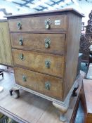 A SMALL WALNUT FOUR DRAWER CHEST ON CABRIOLE LEGS.