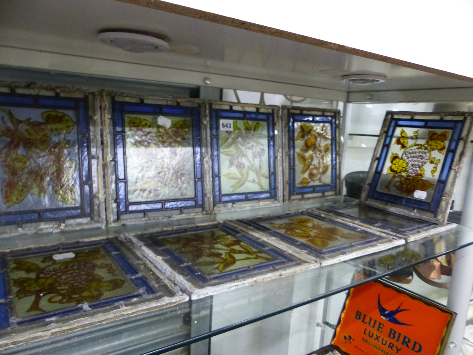 TEN LEADED GLASS PANELS PAINTED WITH FRUIT AND FOLIAGE, EACH 23 x 19cms.