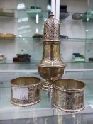 A HALLMARKED SILVER CASTER AND TWO NAPKIN RINGS.