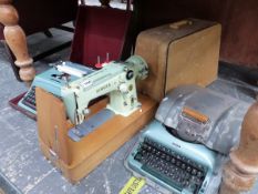 A RETRO MID CENTURY ALLOY CASED IMPERIAL TYPE WRITER, A LATER OLIVETTI STUDIO 44 TYPEWRITER AND A