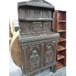 AN ANTIQUE AND LATER CARVED COLONIAL HARDWOOD SIDE CABINET WITH FIGURAL PANEL DOORS.