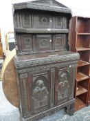 AN ANTIQUE AND LATER CARVED COLONIAL HARDWOOD SIDE CABINET WITH FIGURAL PANEL DOORS.