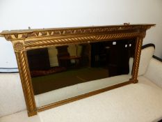 AN ANTIQUE GILT FRAME OVER MANTLE MIRROR.