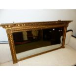 AN ANTIQUE GILT FRAME OVER MANTLE MIRROR.