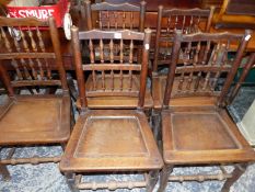 A SET OF FIVE ANTIQUE SPINDLE BACK OAK PANEL SEAT CHAIRS.