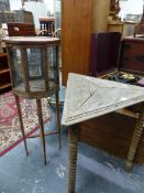 A TRIANGULAR OAK TABLE ON THREE SPINDLE LEGS TOGETHER WITH OCTAGONAL DISPLAY CABINET WITH GLAZED