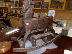 AN EASTERN CARVED HARD WOOD ROCKING HORSE.