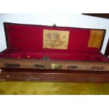 AN ANTIQUE HOLLAND AND HOLLAND GUN CASE AND ANOTHER LATER CASE (2).