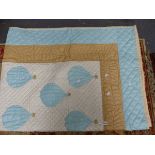 A PATCHWORK QUILT SEWN WITH BLUE HOT AIR BALLOONS