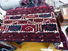 AN ANTIQUE CAUCASIAN MAT TOGETHER WITH A TURKOMAN CAMEL TRAPPING (2)