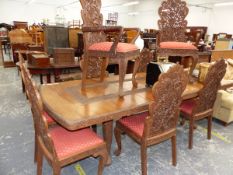 AN IMPRESSIVE LARGE TEAK CARVED DINING TABLE TOGETHER WITH EIGHT MATCHING CARVED CHAIRS. W 261 X D