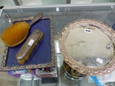 A HALLMARKED SILVER PHOTO FRAME, AN EASTERN WHITE METAL TRAY, AND TWO SILVER BACKED BRUSHES.