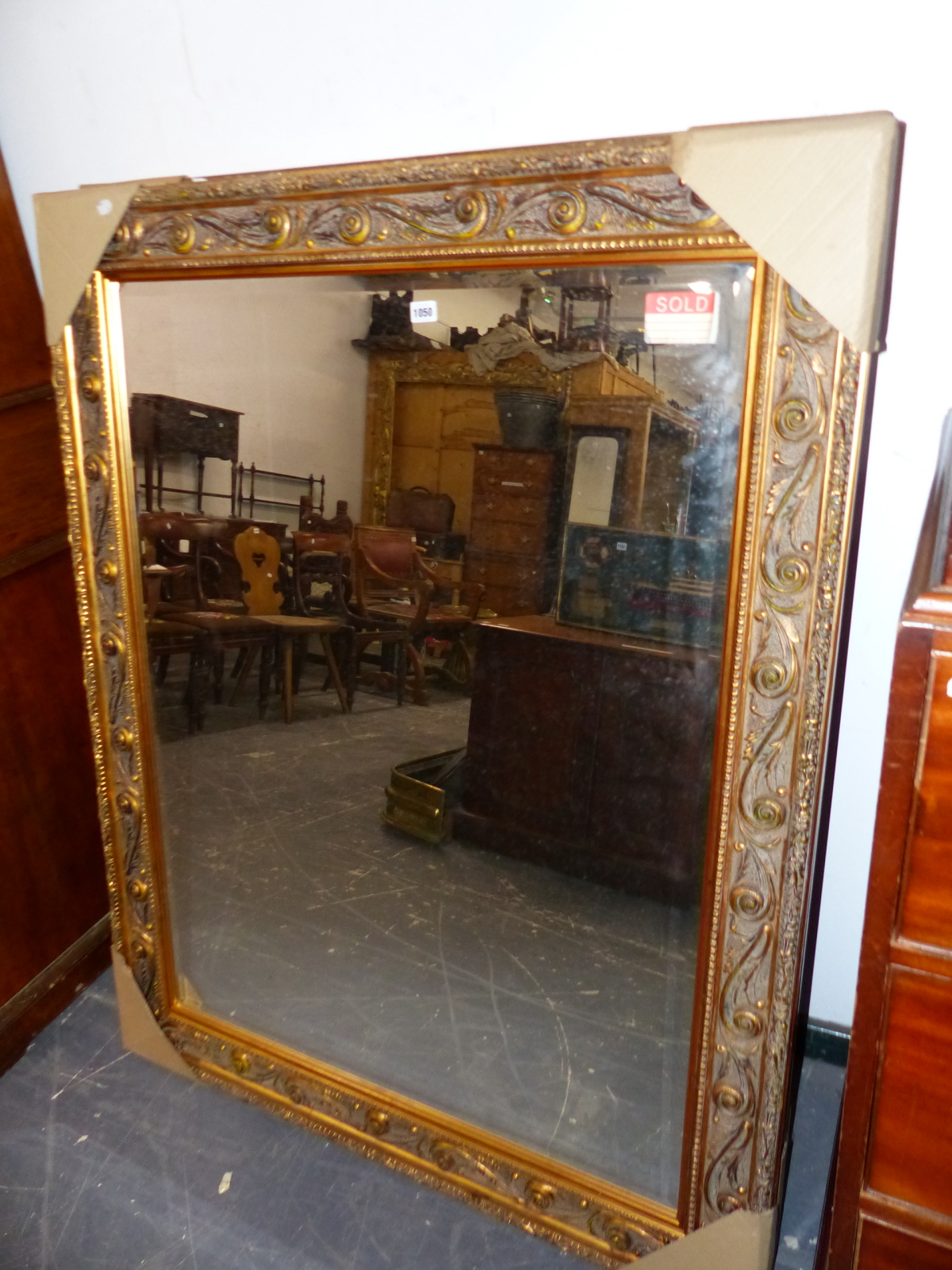 THREE LARGE ANTIQUE STYLE GILT FRAMED WALL MIRRORS AND A MATCHING SILVERED FRAMED EXAMPLE (4)
