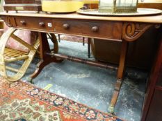 A VICTORIAN MAHOGANY TWO DRAWER WRITING TABLE ON TRESSLE END SUPPORTS WITH BRASS CASTERS. W 130 X