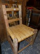 AN ANTIQUE IRISH COUNTRY RUSH SEAT SIDE CHAIR.