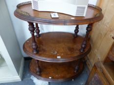 A VICTORIAN WALNUT THREE TIER OVAL ETAGERE.