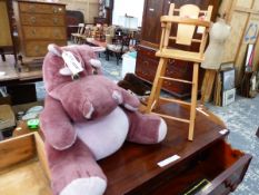 A PURPLE PLUSH HIPPO TEDDY AND A DOLLS HIGH CHAIR.