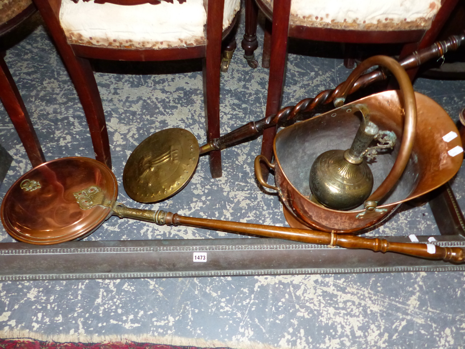 A LARGE COPPER COAL SKUTTLE, COPPER FENDER, TWO WARMING PANS AND AN EASTERN BRASS JUG.